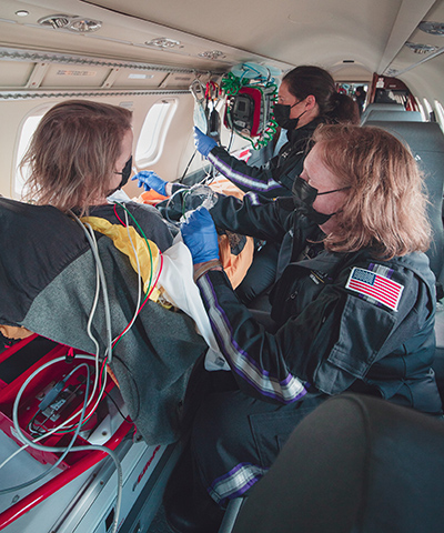 Airlift Northwest flight nurses care for a patient during transport.