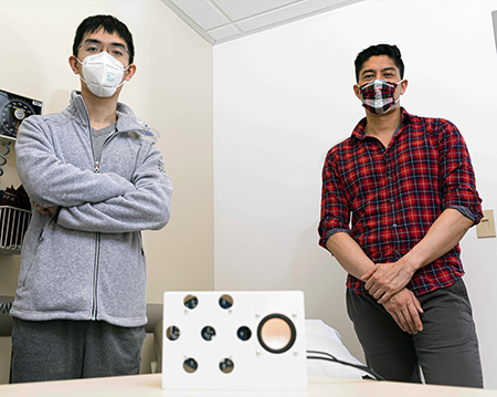 picture of study authors Anran Wang and Dan Nguyen with the smart speaker prototype