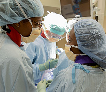 picture of Dr. Estell Williams and a medical trainee in the operating room