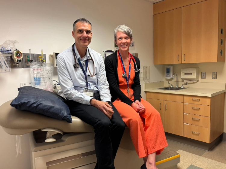 Drs. Yonatan Buber and Catherine Albright sit in a patient room