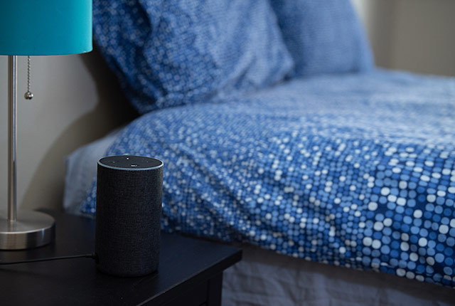 picture of a smart speaker beside a bed