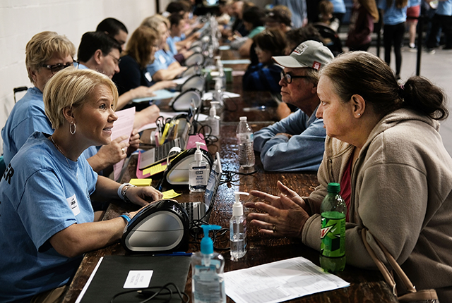 picture of woman discussing needs at health fair event in rural New York