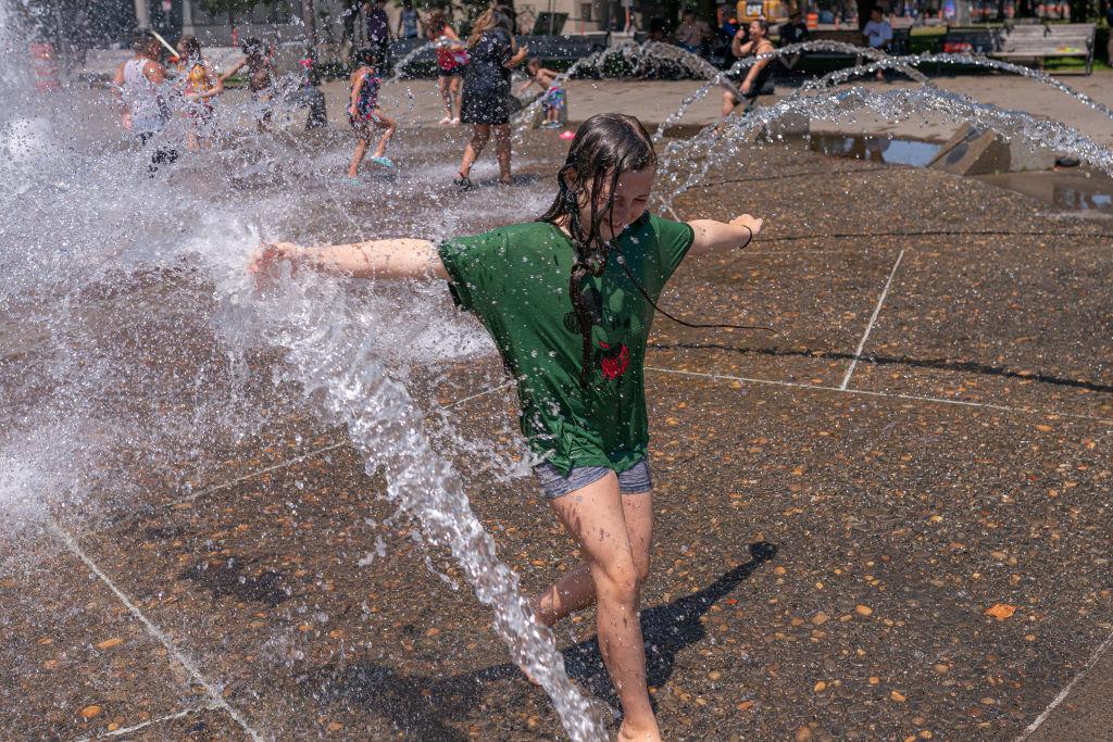 children playing in fountain during record Portland heat