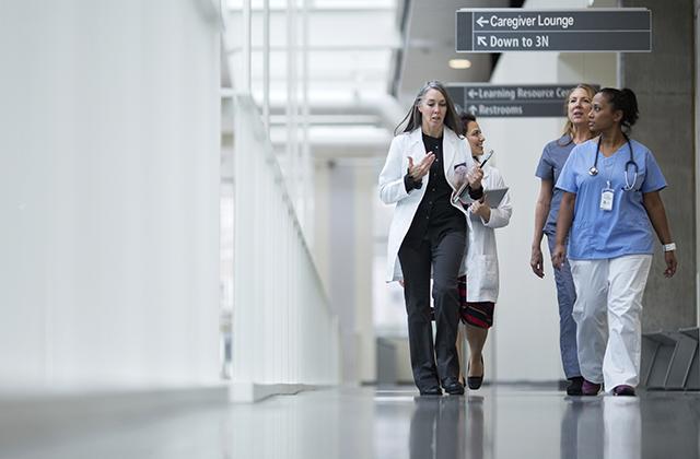 picture of clinicians walking in hospital corridor