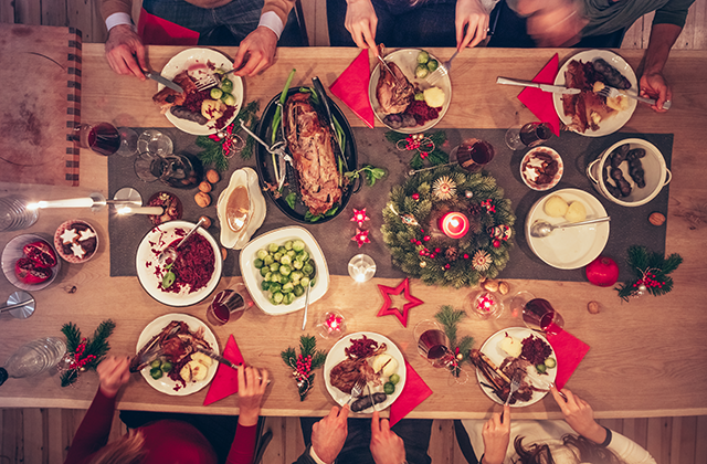 overhead picture of people eating at a holiday dinner