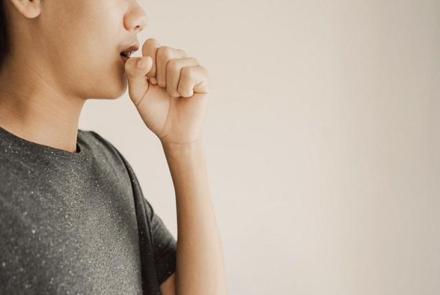Man coughing into his hand