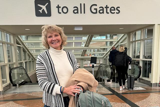 Linda Eckert walking in Denver airport on her way to DC conference.