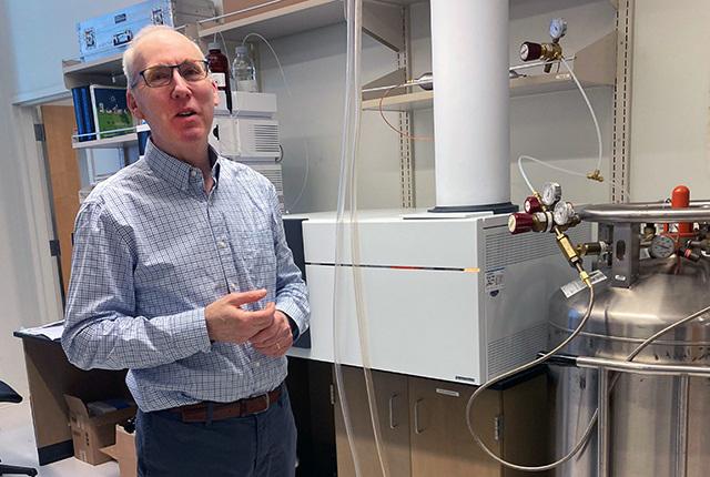 Metabolomics researcher Daniel Raftery in front of a mass spectrometer in his lab at the UW Medicine Mitochondria & Metabolism Center