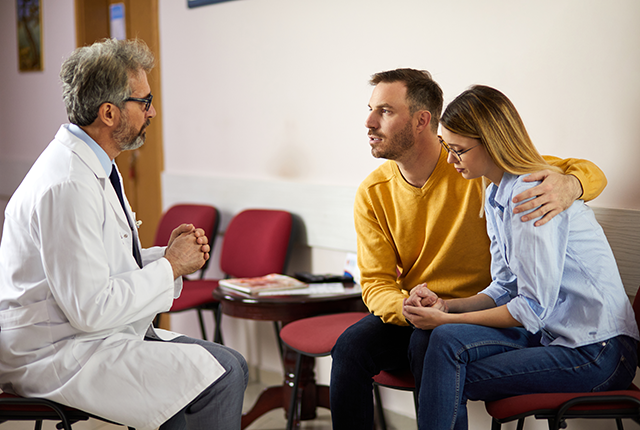 picture of doctor talking with a man and woman