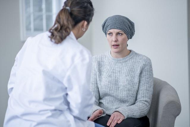 Young woman with colon cancer talking with her doctor..