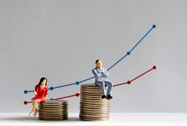 picture of figurines of man and woman sitting on different heights of coins