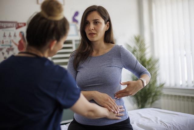 Worried woman talking to a nurse