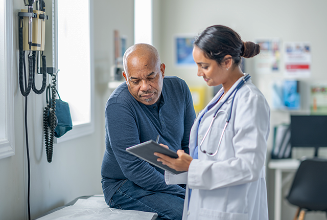 picture of doctor talking with an older male patient