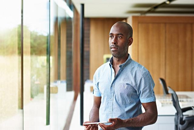 Black man looking out the window