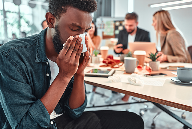 picture of man with a cold blowing his nose