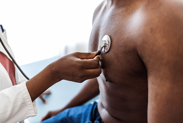 picture of shirtless black male getting checked with stethoscope