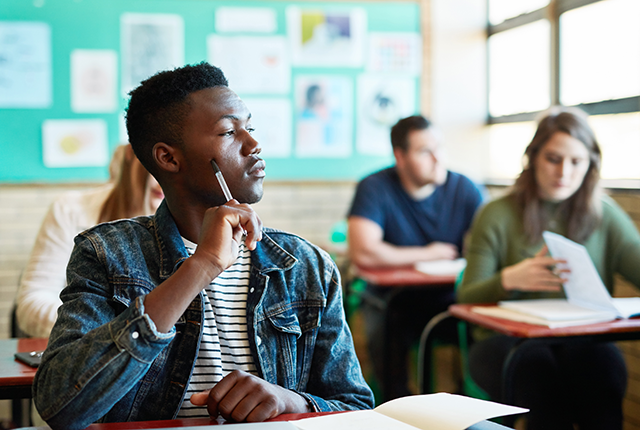 picture of college student being distracted in class