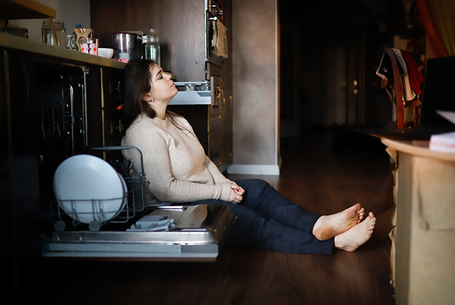 picture of woman sitting on the floor in her kitchen