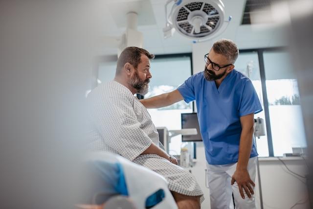 picture of a clinician talking with a middle age male patient who is obese