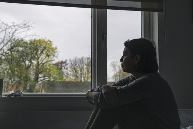 woman looking out the window