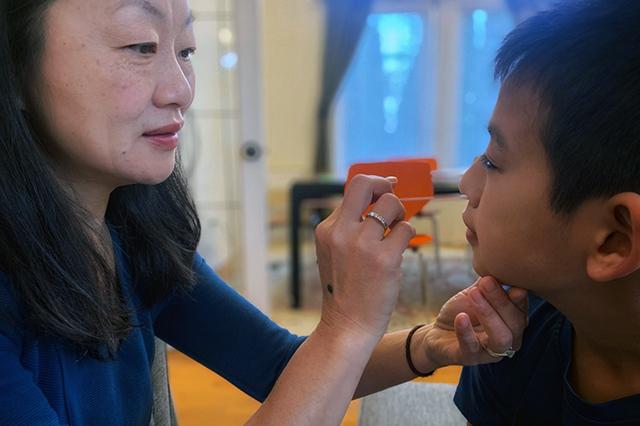 Dr. Helen Chu demonstrates how to take a nasal swab