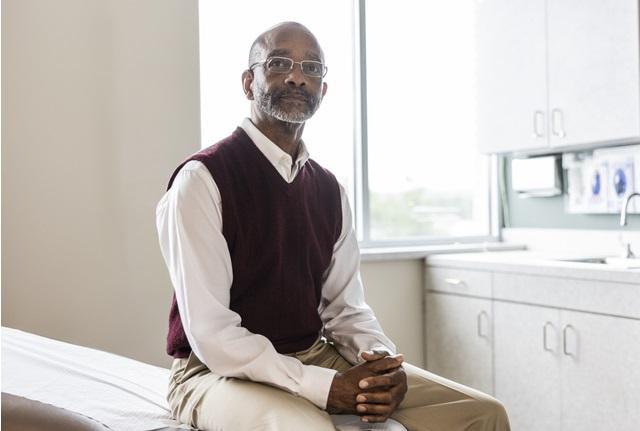 Black man sitting in doctor's office.