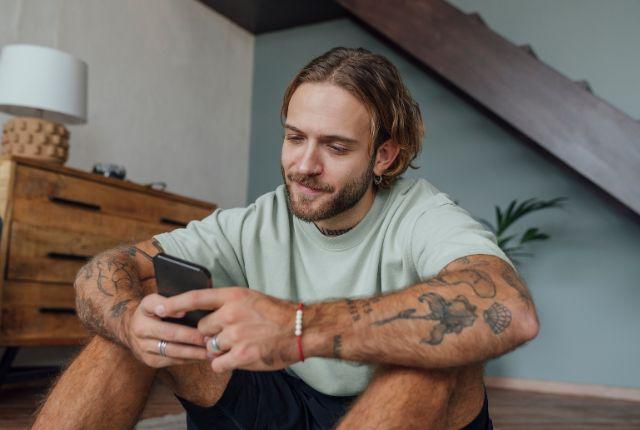 Image of a person texting with a calm look on their face