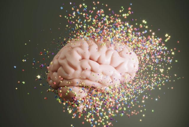 Illustration of a brain composed of multicolored cubes that are flying apart