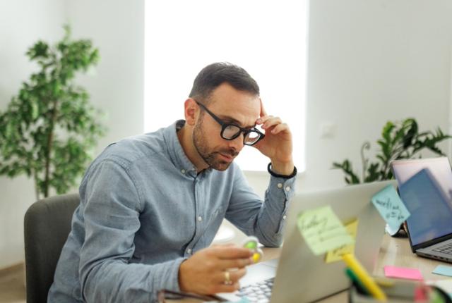 picture of a man working in an office using fidget spinner
