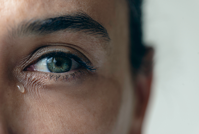 a woman's eye with a tear underneath