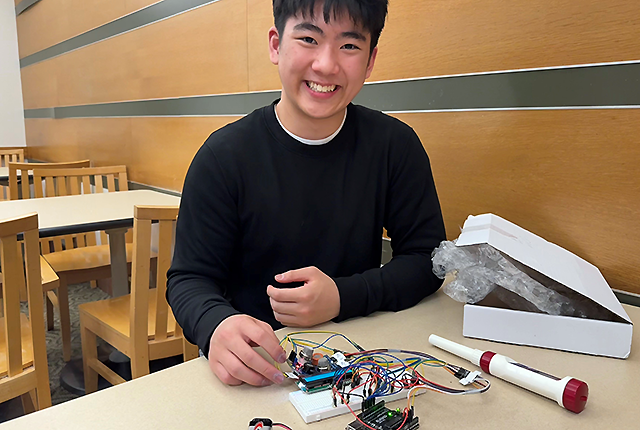 At UW Medical Center – Montlake, where he receives care, Oliver Cho displays his invention.