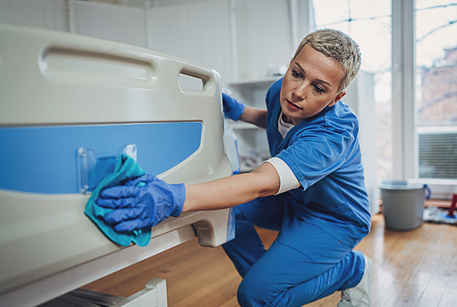 nurse sanitizes a hospital room