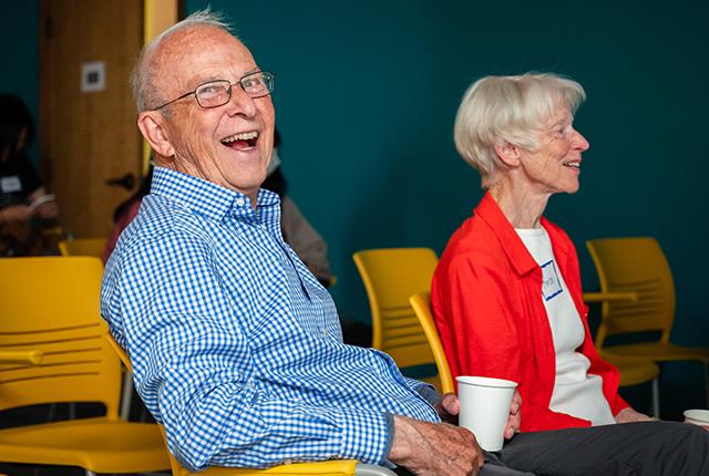 picture of an older man laughing at a memory cafe event