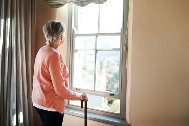 Media Name: elderly_woman_at_window_gettyimages-1165370152.jpg