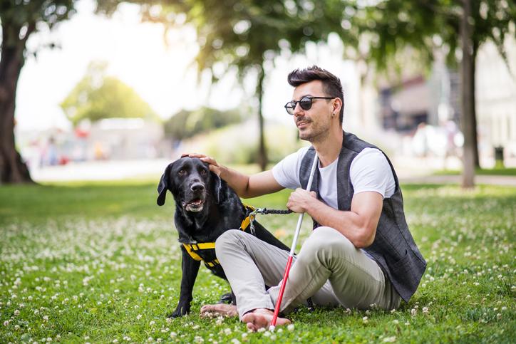 Media Name: person_with_low_vision_and_dog_1179580885.jpg
