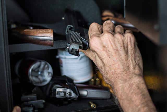 Media Name: senior_reaching_for_a_gun_in_safe.jpg
